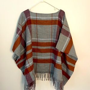 Brand new WITH TAGS. Grey and orange plaid poncho. One size.